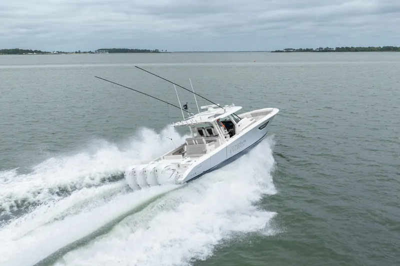 Slide: The Image of 2023 Pursuit S 428 Sport boat speeding on open water. - 13