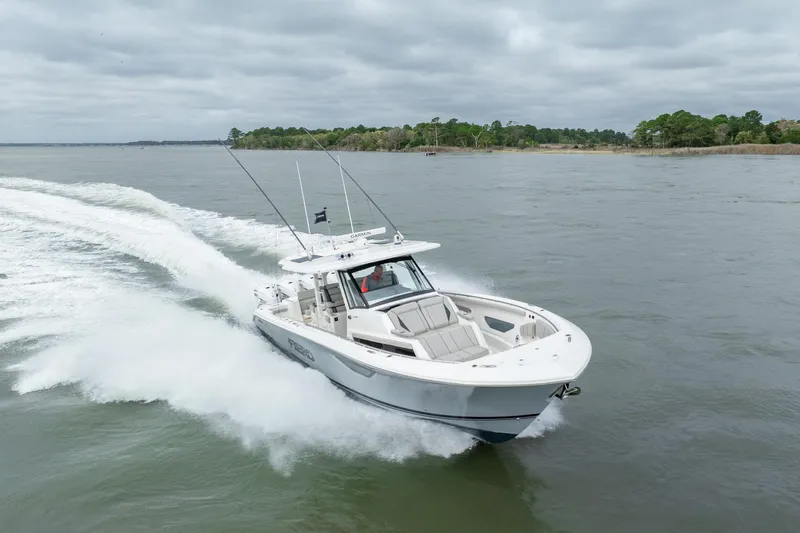 Slide: The Image of 2023 Pursuit S 428 Sport boat cruising on open water. - 16