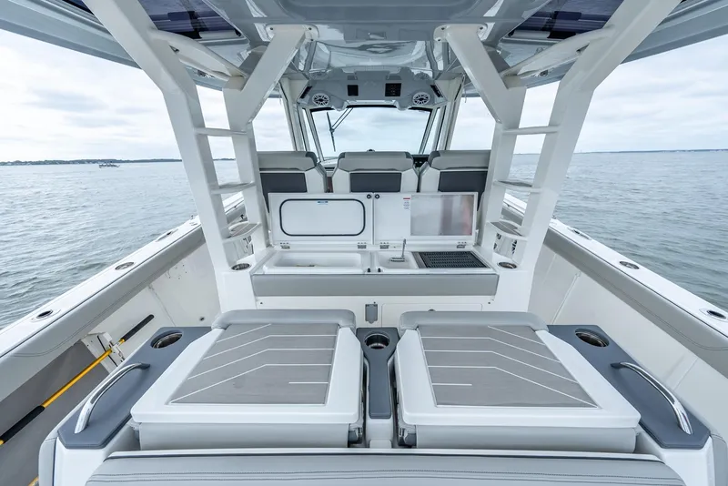 Slide: The Image of 2023 Pursuit S 428 Sport boat interior with sleek seating and modern design on open water. - 26