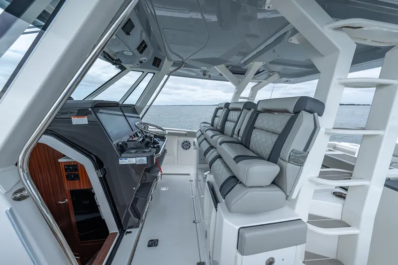 Slide: The Image of Interior of 2023 Pursuit S 428 Sport boat with luxurious seating and helm. - 28