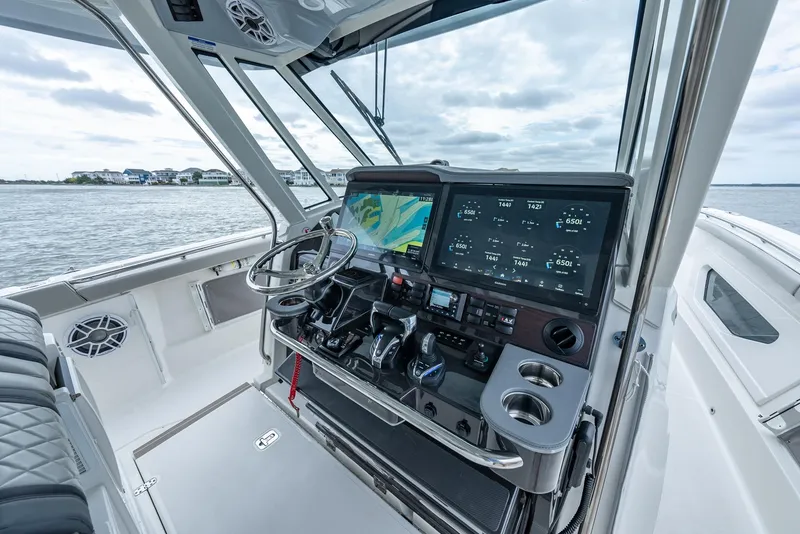 Slide: The Image of 2023 Pursuit S 428 Sport boat cockpit with advanced navigation system and steering wheel. - 32