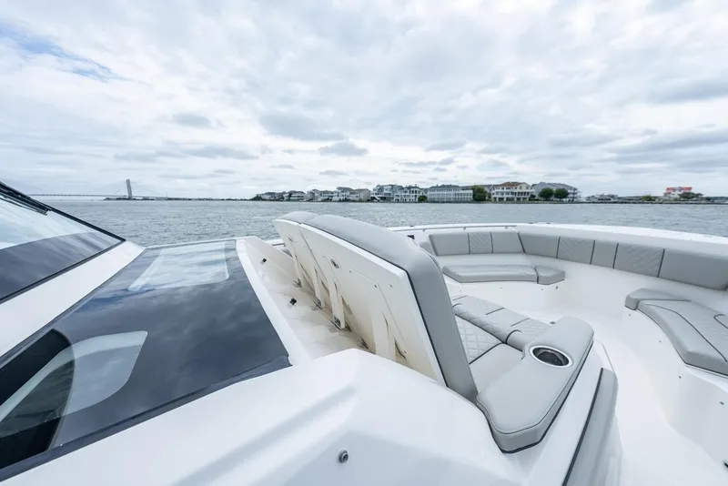 Slide: The Image of 2023 Pursuit S 428 Sport boat on calm waters, featuring luxurious seating. - 33