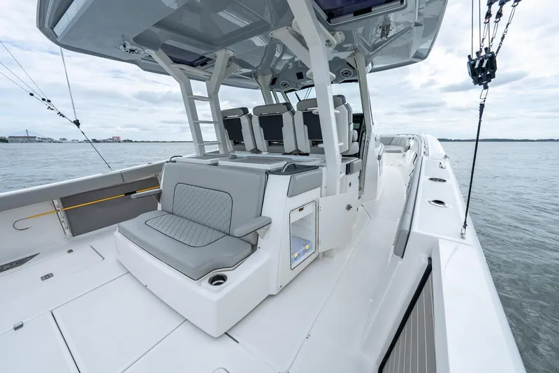 Slide: The Image of 2023 Pursuit S 428 Sport boat with spacious seating and sleek design on open water. - 34