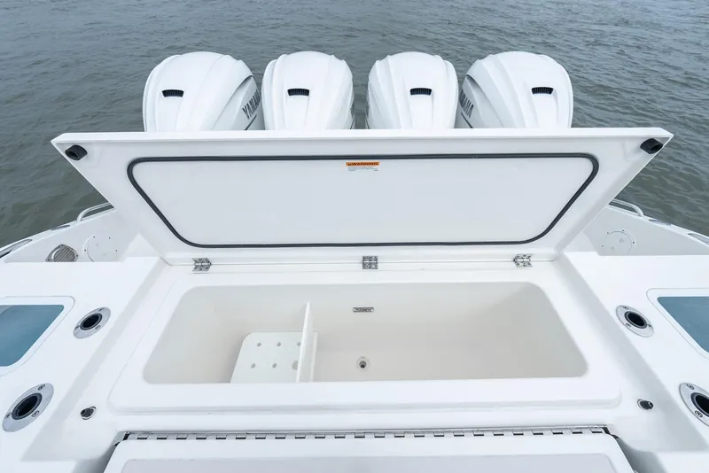 Slide: The Image of 2023 Pursuit S 428 Sport boat with open storage compartment and four powerful engines. - 37