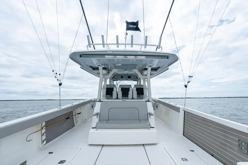 Slide: The Image of 2023 Pursuit S 428 Sport boat on open water, showcasing spacious deck and modern design. - 39