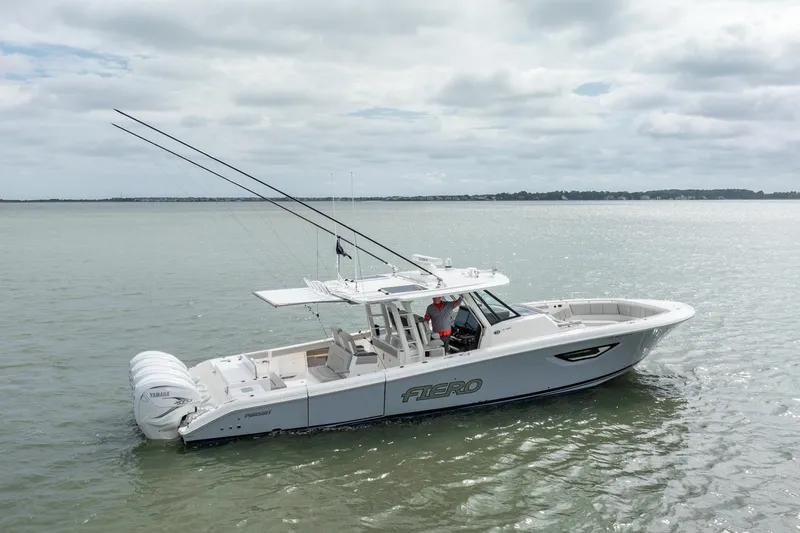 Slide: The Image of 2023 Pursuit S 428 Sport boat on calm water, featuring sleek design and powerful engines. - 4