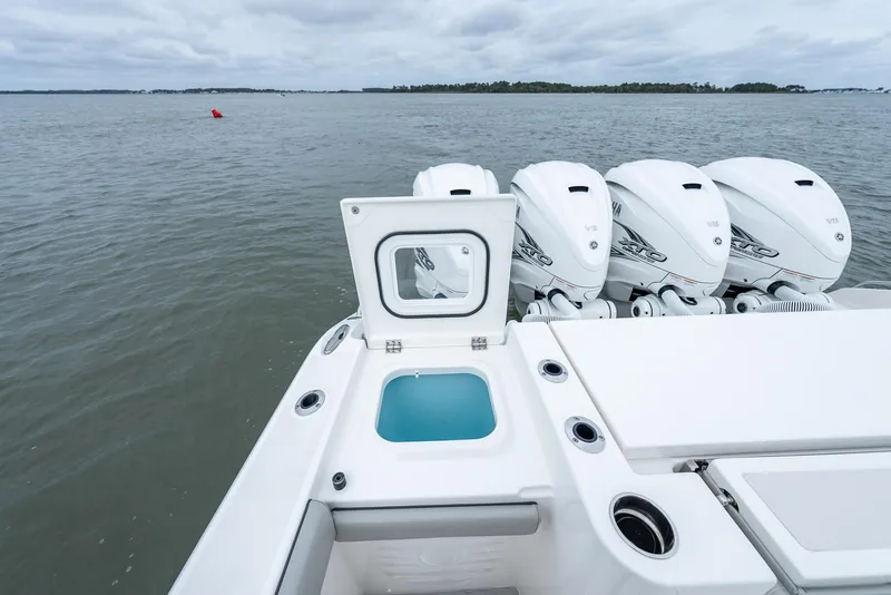 Slide: The Image of 2023 Pursuit S 428 Sport boat with four powerful outboard engines on open water. - 40