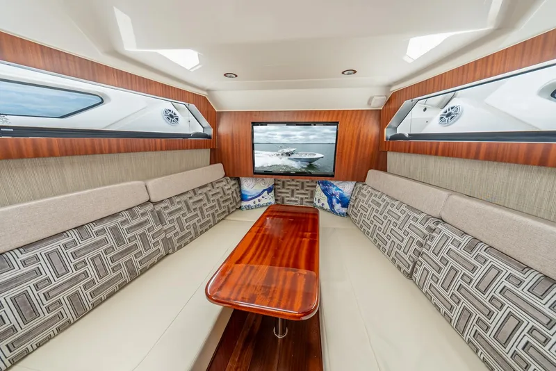 Slide: The Image of Luxurious interior of 2023 Pursuit S 428 Sport boat with elegant seating and wooden table. - 44