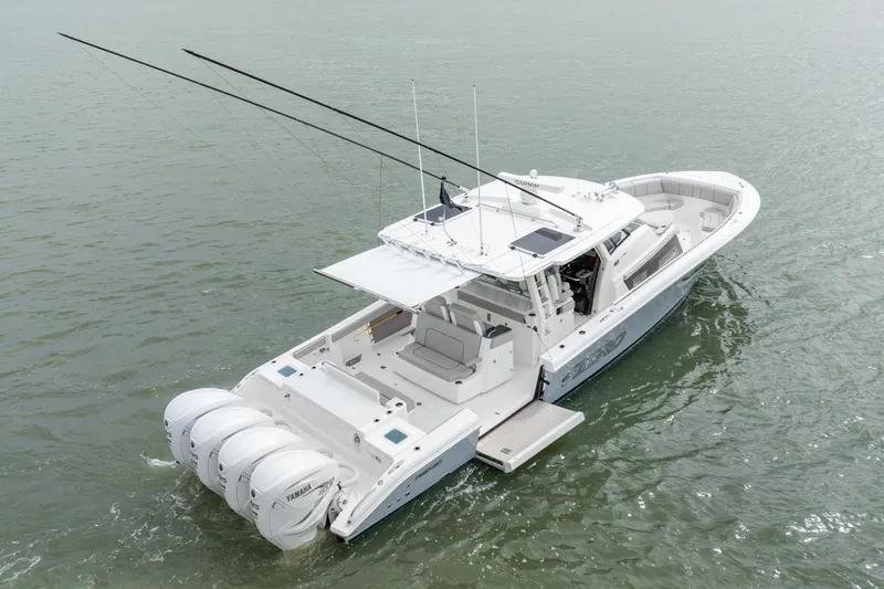 Slide: The Image of 2023 Pursuit S 428 Sport boat on water, featuring triple outboard engines. - 6