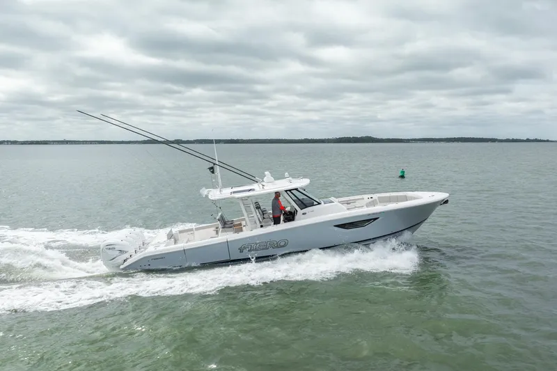 Slide: The Image of 2023 Pursuit S 428 Sport boat cruising on open water under cloudy skies. - 8