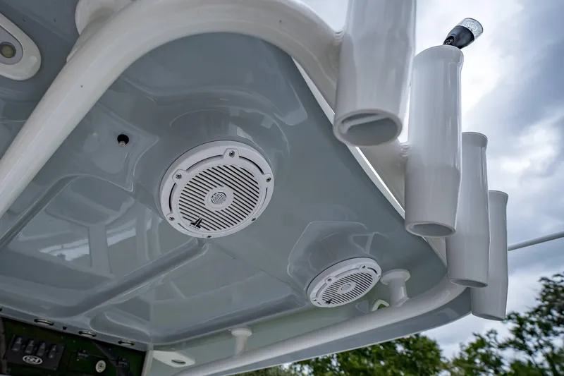 Slide: The Image of 2025 Sea Hunt Ultra 239 SE boat speakers and rod holders under T-top. - 12