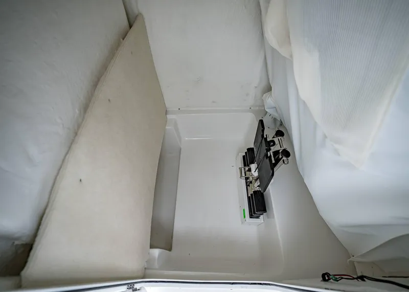 Slide: The Image of Interior compartment of 2025 Sea Hunt Ultra 239 SE boat, featuring storage space. - 16