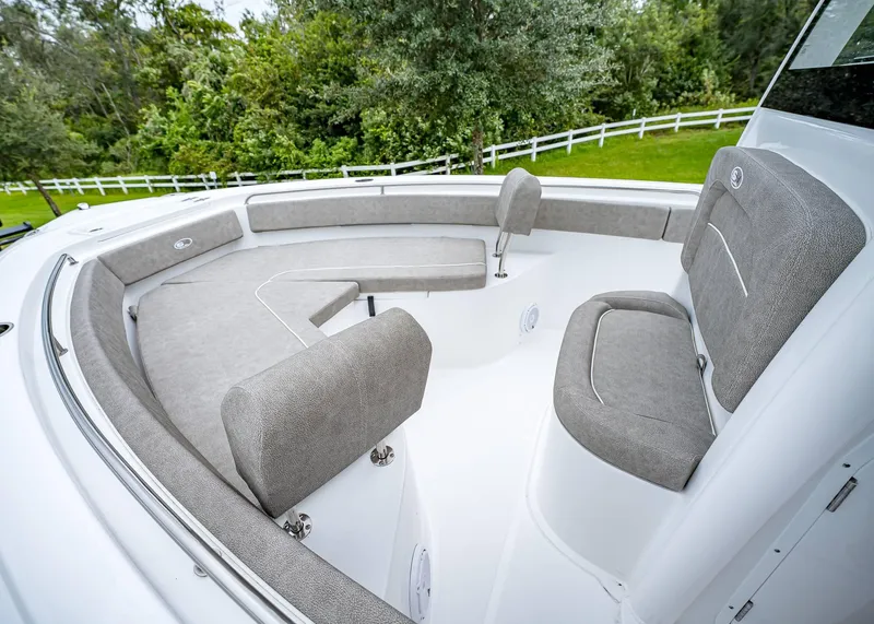 Slide: The Image of 2025 Sea Hunt Ultra 239 SE boat interior with gray seating and white deck. - 17