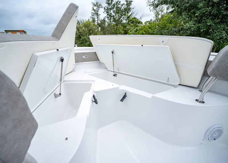 Slide: The Image of 2025 Sea Hunt Ultra 239 SE boat storage compartments open, showcasing spacious interior design. - 19