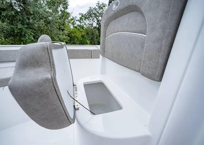 Slide: The Image of 2025 Sea Hunt Ultra 239 SE boat seat with storage compartment open. - 22