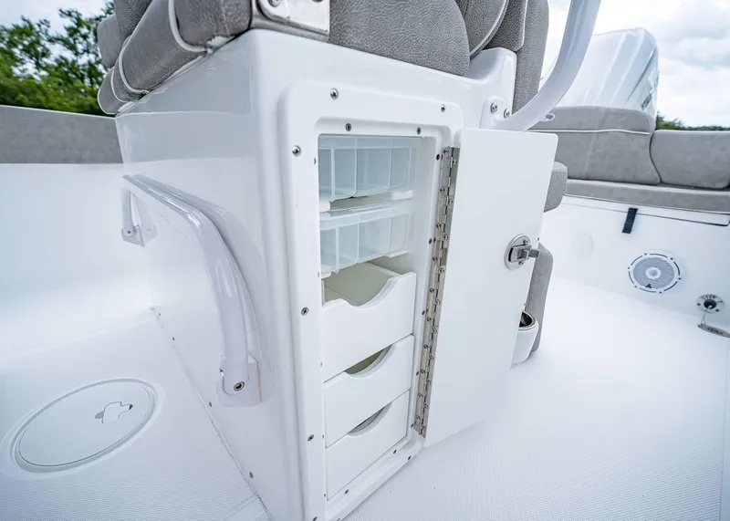 Slide: The Image of 2025 Sea Hunt Ultra 239 SE boat storage compartment with open drawers. - 23