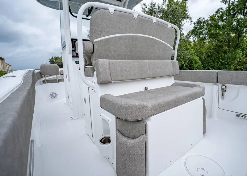 Slide: The Image of 2025 Sea Hunt Ultra 239 SE boat interior with cushioned seating and storage. - 6