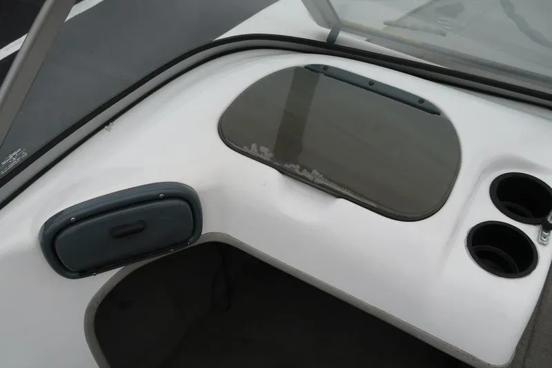 Slide: The Image of 2005 ProCraft 181 Combo boat interior with storage compartment and cup holders. - 11