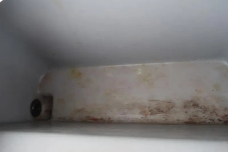 Slide: The Image of Interior of a 2005 ProCraft 181 Combo boat showing storage compartment. - 13