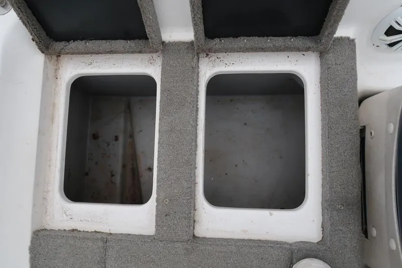 Slide: The Image of 2005 ProCraft 181 Combo boat storage compartments, carpeted interior, open lids. - 14