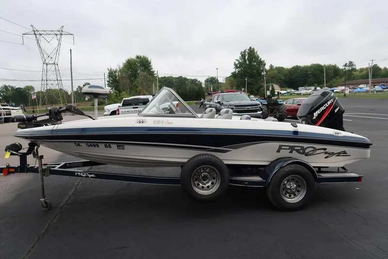 Slide: The Image of 2005 ProCraft 181 Combo boat on trailer, parked outdoors. - 21