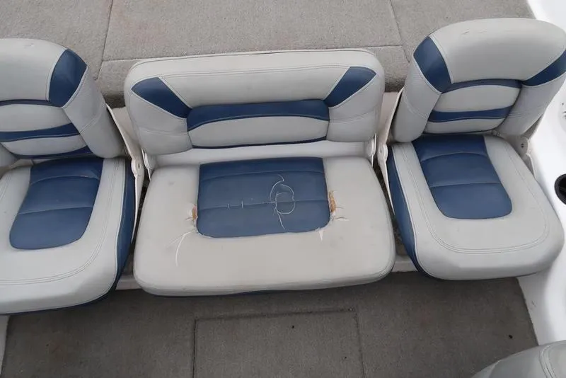Slide: The Image of 2005 ProCraft 181 Combo boat seats with blue and white upholstery, showing wear and tear. - 9