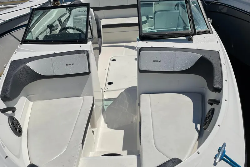 Slide: The Image of 2016 Sea Ray 21SPX-OB boat interior with spacious seating and open deck layout. - 10