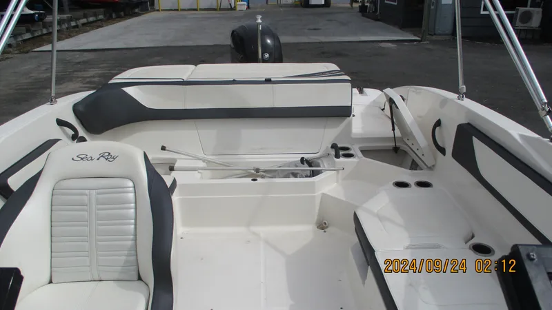 Slide: The Image of 2016 Sea Ray 21SPX-OB boat interior with seating and storage areas. - 11