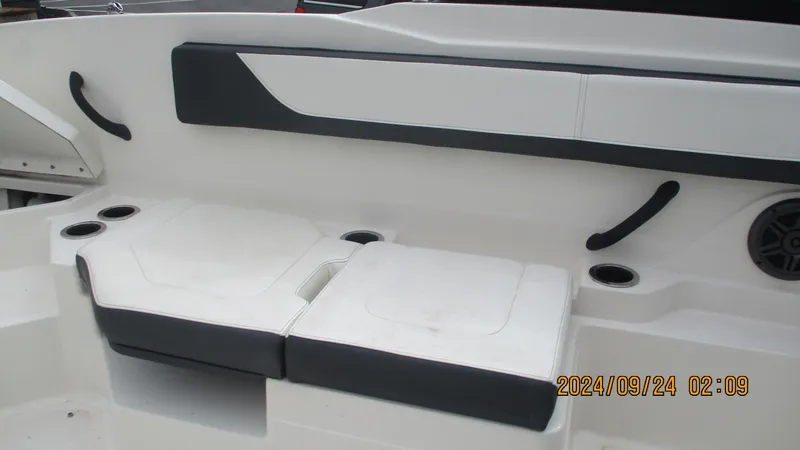 Slide: The Image of 2016 Sea Ray 21SPX-OB boat interior seating with cup holders and speaker. - 12