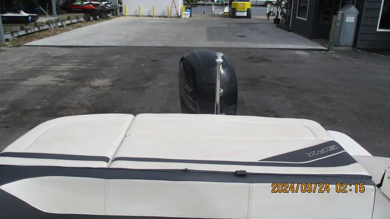 Slide: The Image of 2016 Sea Ray 21SPX-OB boat with outboard motor, docked on a paved surface. - 13