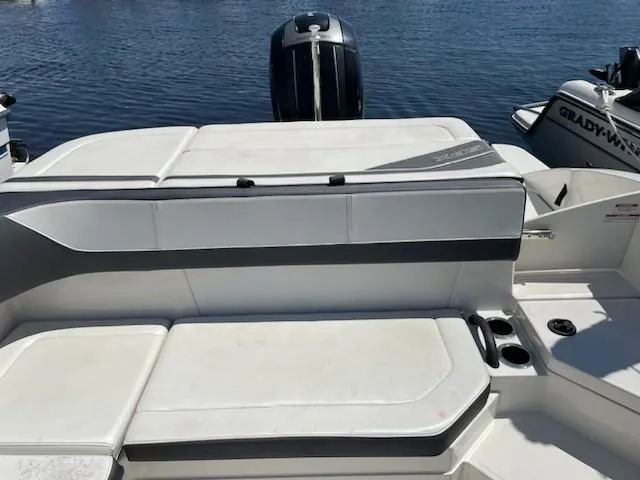 Slide: The Image of 2016 Sea Ray 21SPX-OB boat with white seating and outboard motor on calm water. - 14