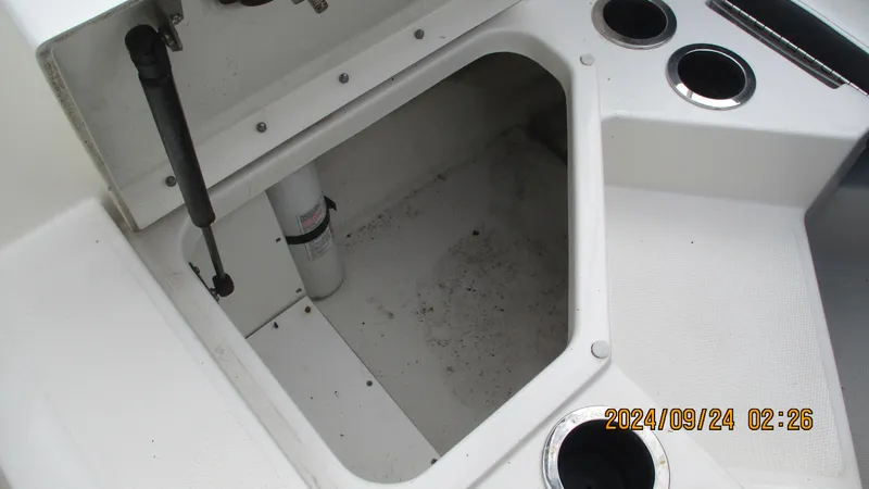 Slide: The Image of Storage compartment of 2016 Sea Ray 21SPX-OB boat with cup holders. - 16