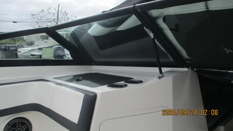 Slide: The Image of 2016 Sea Ray 21SPX-OB boat interior with windshield and cup holders. - 17
