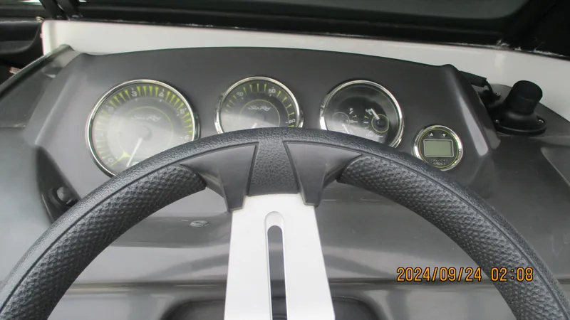 Slide: The Image of Dashboard of a 2016 Sea Ray 21SPX-OB boat with steering wheel and gauges. - 19