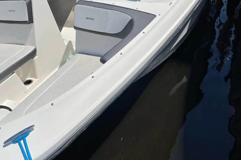 Slide: The Image of 2016 Sea Ray 21SPX-OB boat, white hull, gray seating, docked on calm water. - 6