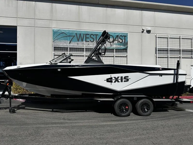 The Image of 2025 Axis T250 boat on trailer outside West Coast dealership. - 1