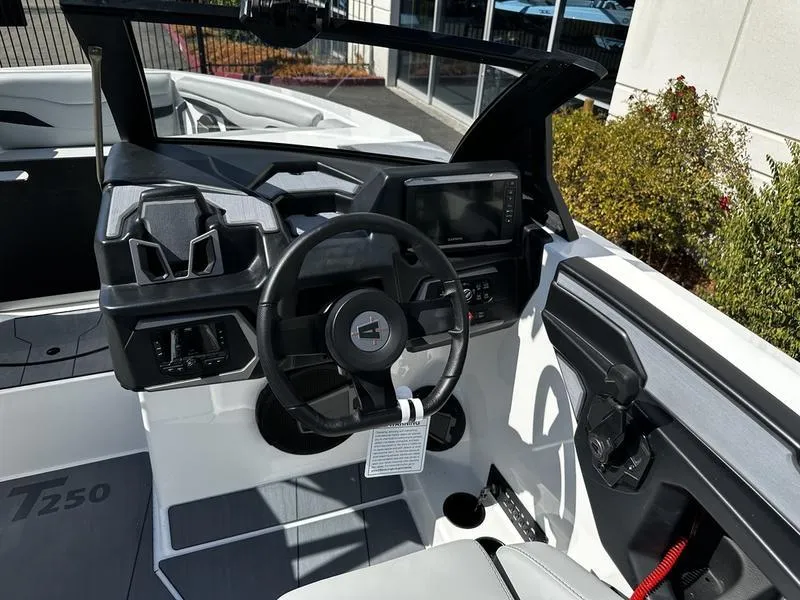 Slide: The Image of 2025 Axis T250 boat interior with modern dashboard and steering wheel. - 6