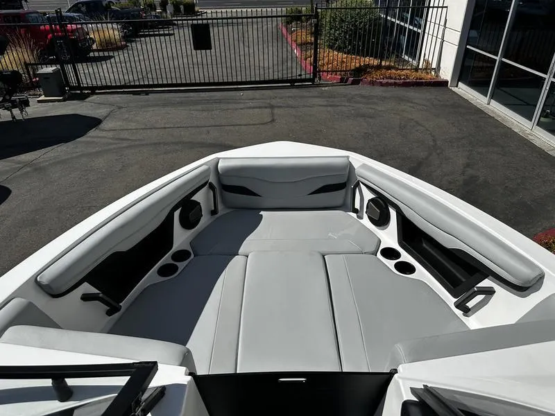 Slide: The Image of 2025 Axis T250 boat interior with gray seating and cup holders. - 8