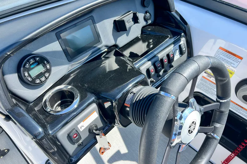 Slide: The Image of 2021 Yamaha Boats SX195 dashboard with steering wheel, controls, and display screen. - 10