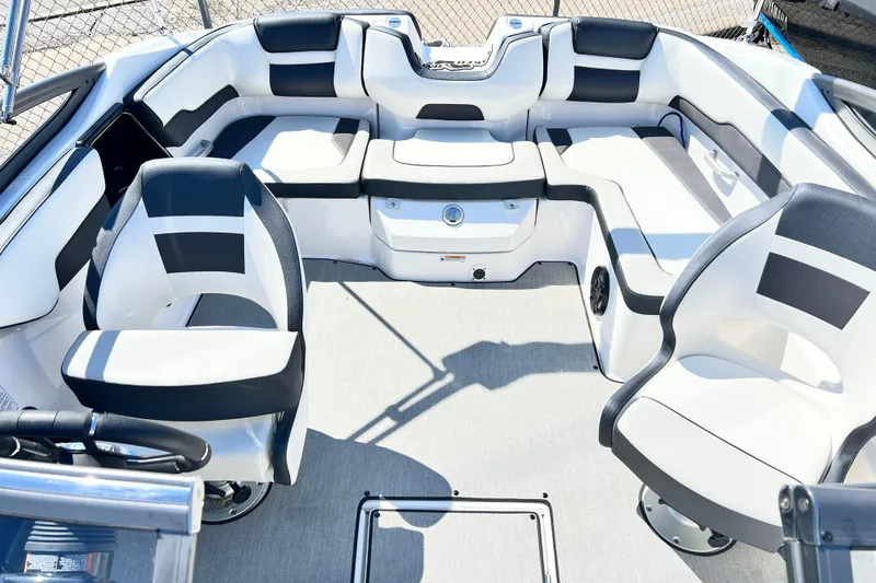 Slide: The Image of 2021 Yamaha Boats SX195 interior with sleek white and black seating arrangement. - 14