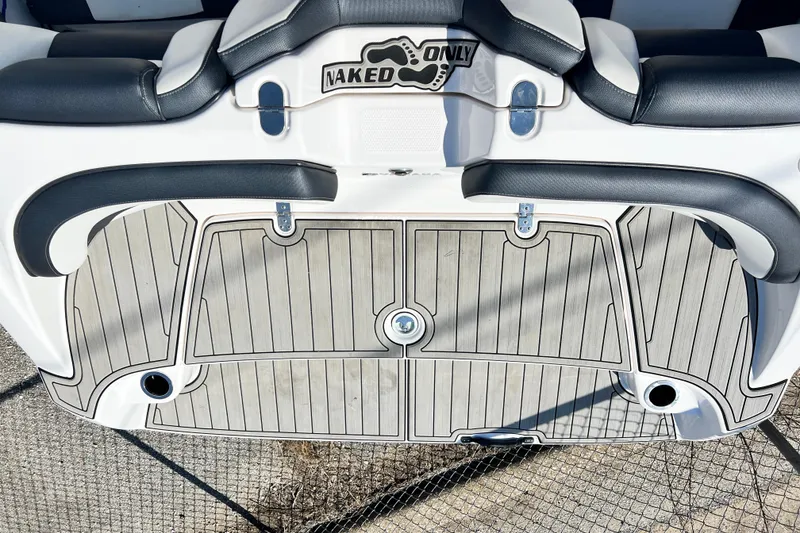 Slide: The Image of 2021 Yamaha Boats SX195 swim platform with "Naked Only" decal, featuring cushioned seating. - 16