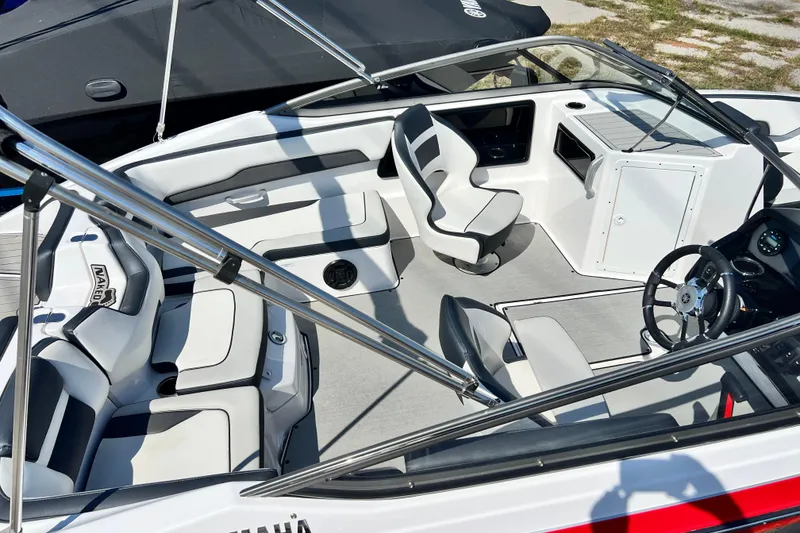 Slide: The Image of 2021 Yamaha Boats SX195 interior with sleek seating and modern dashboard design. - 18