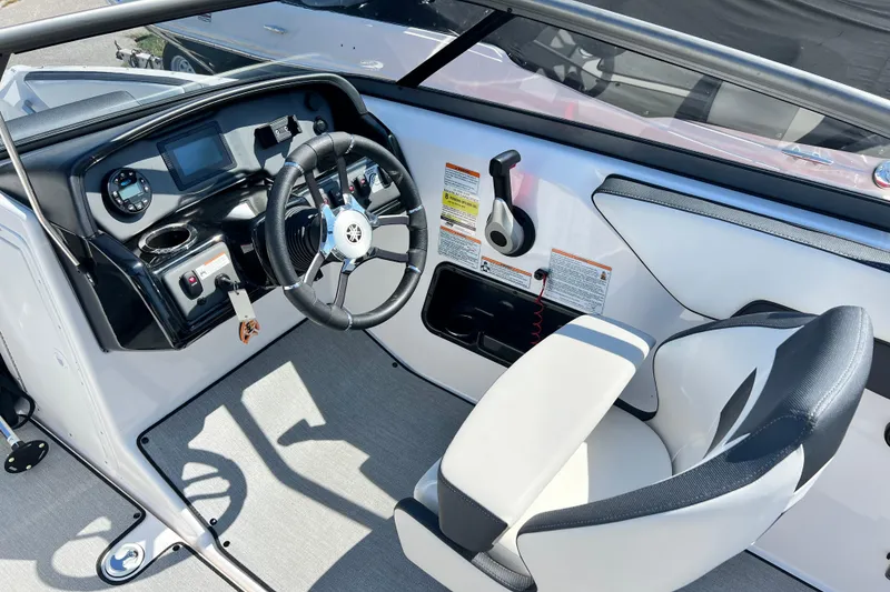 Slide: The Image of 2021 Yamaha Boats SX195 cockpit with steering wheel and control panel. - 9