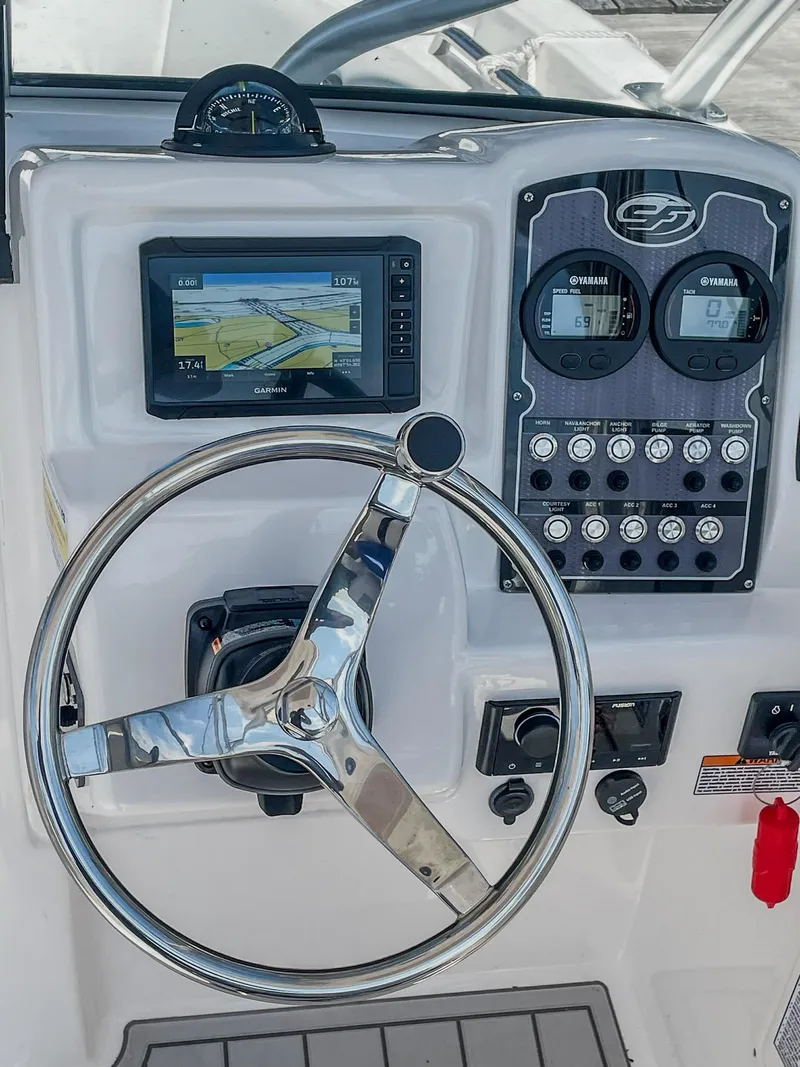 Slide: The Image of 2024 Sea Fox 228 Traveler dashboard with steering wheel and navigation display. - 14