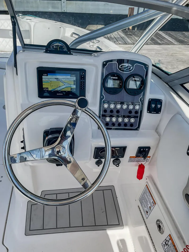 Slide: The Image of 2024 Sea Fox 228 Traveler boat dashboard with steering wheel and navigation controls. - 15
