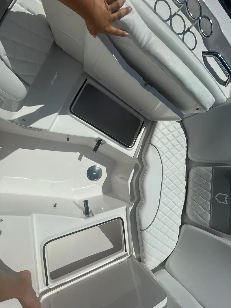 Slide: The Image of 2024 Sea Fox 228 Traveler boat interior with white seating and storage compartments. - 17