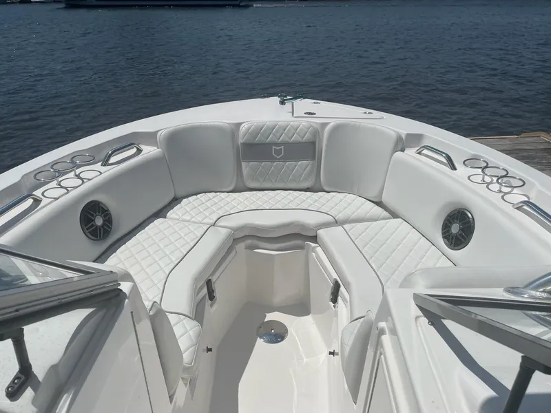 Slide: The Image of 2024 Sea Fox 228 Traveler boat interior with white cushioned seating and cup holders. - 18