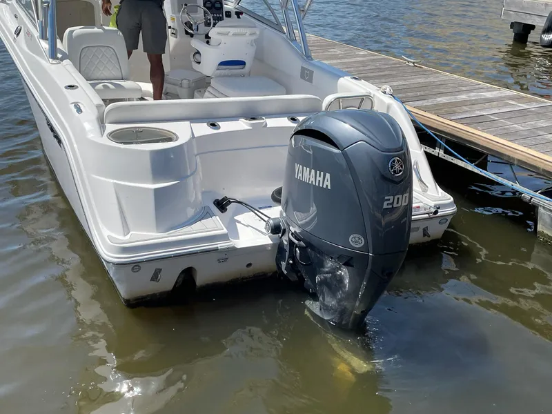 Slide: The Image of 2024 Sea Fox 228 Traveler boat with Yamaha 200 outboard motor docked in water. - 4