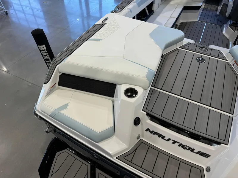 Slide: The Image of 2025 Nautique Super Air Nautique GS22 boat interior with sleek seating and modern design. - 12