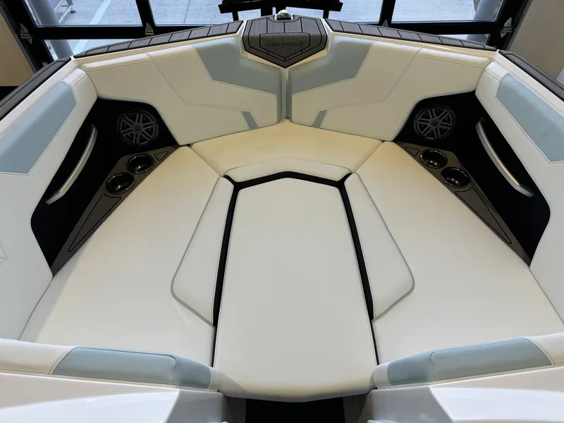 Slide: The Image of 2025 Nautique Super Air Nautique GS22 interior with white seating and cup holders. - 17